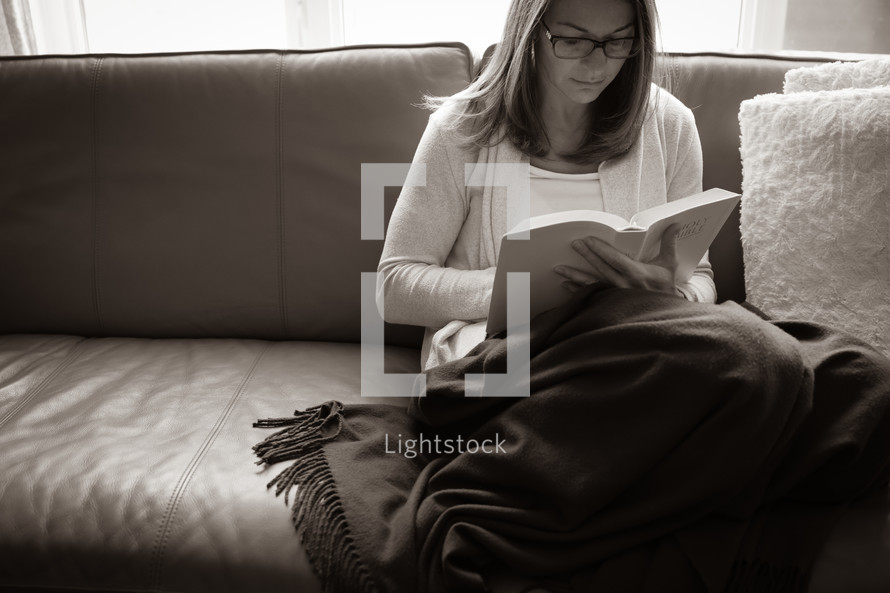 Woman with green blanket reading the Bible - black and white
