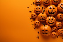 Halloween pumpkins on orange background with copy space. Halloween background
