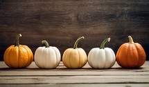 Colorful pumpkins on wooden background. Halloween or Thanksgiving concept.
