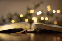 bokeh lights and open Bible at Christmas 