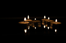 tea light candles in darkness 