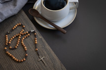 rosary, coffee cup, and wooden spoon 