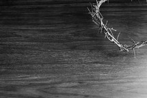 Partial crown of thorns on a dark wood background