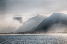 rising steam over mountains along a coastline in Africa 