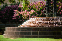 Tiered water fountain outdoors in a park.