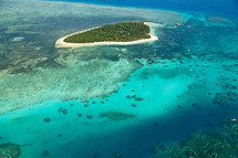 aerial view over an island and reef 
