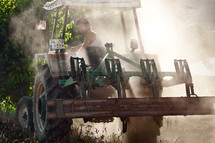 Male farmer driving tractor 