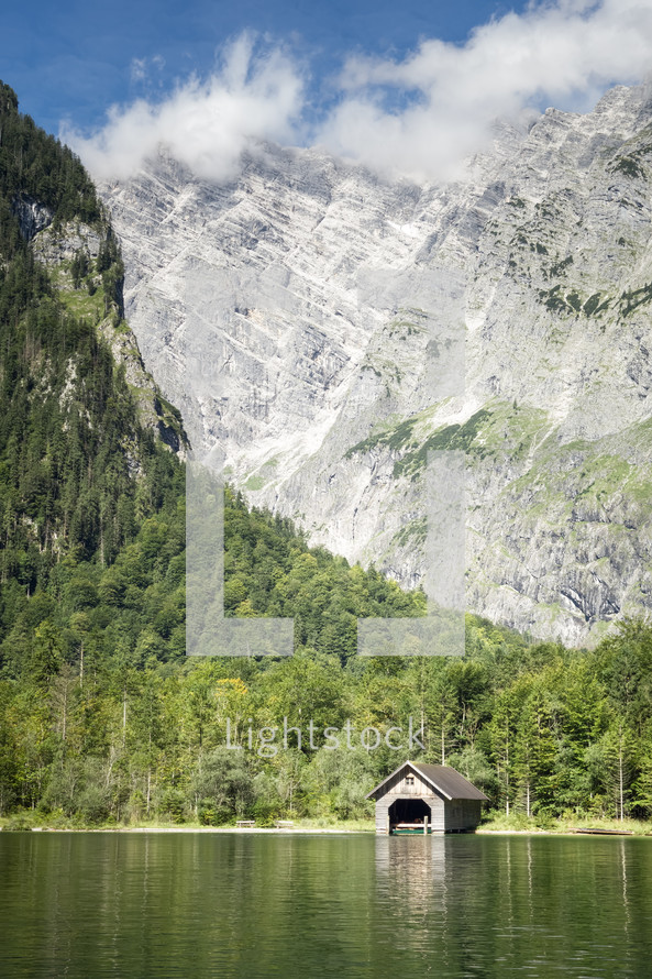 boat house on a lake and mountain peaks 