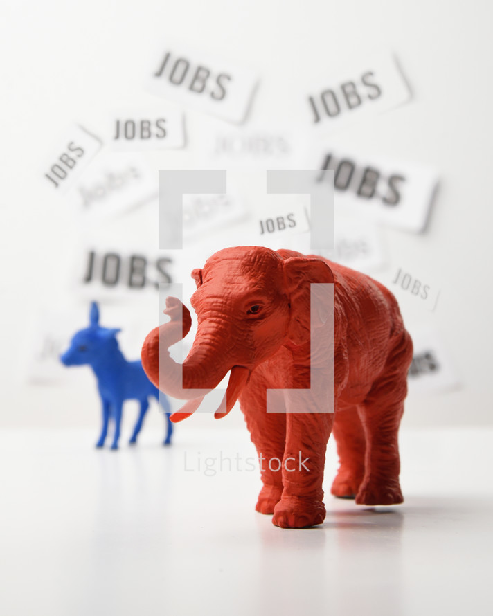 A blue donkey and a red elephant are againts a white wall that has job text in the background for a 2020 political issue of employment rate and the economy.