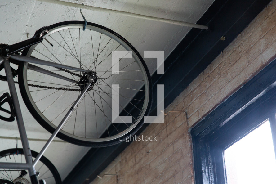 bike hanging from a ceiling in an apartment 