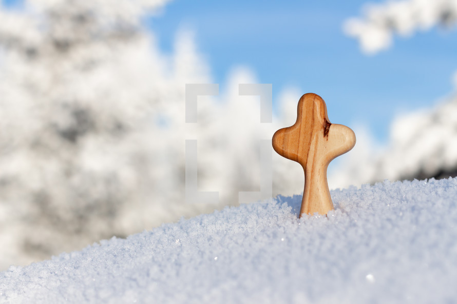 wooden cross in snow 
