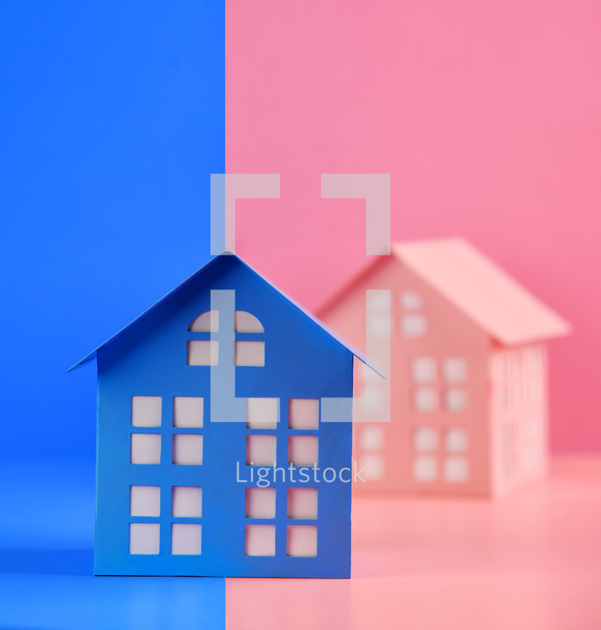 A blue house is divided between two colors, pink and blue for a gender identity concept.