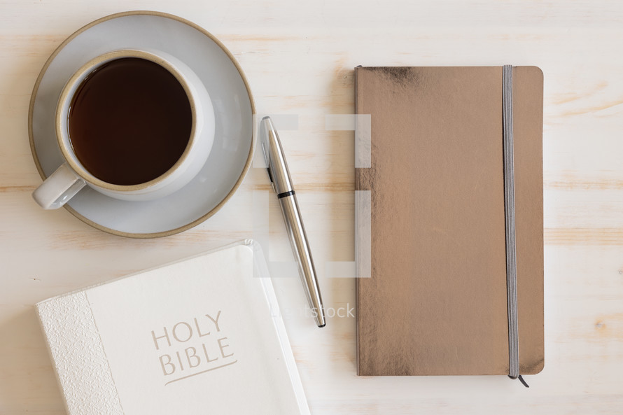 coffee cup, Bible, and journal 