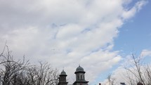 Timelapse With Church, Flying Birds And Moving Clouds