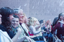 snow falling on a congregation during an outdoors worship service 