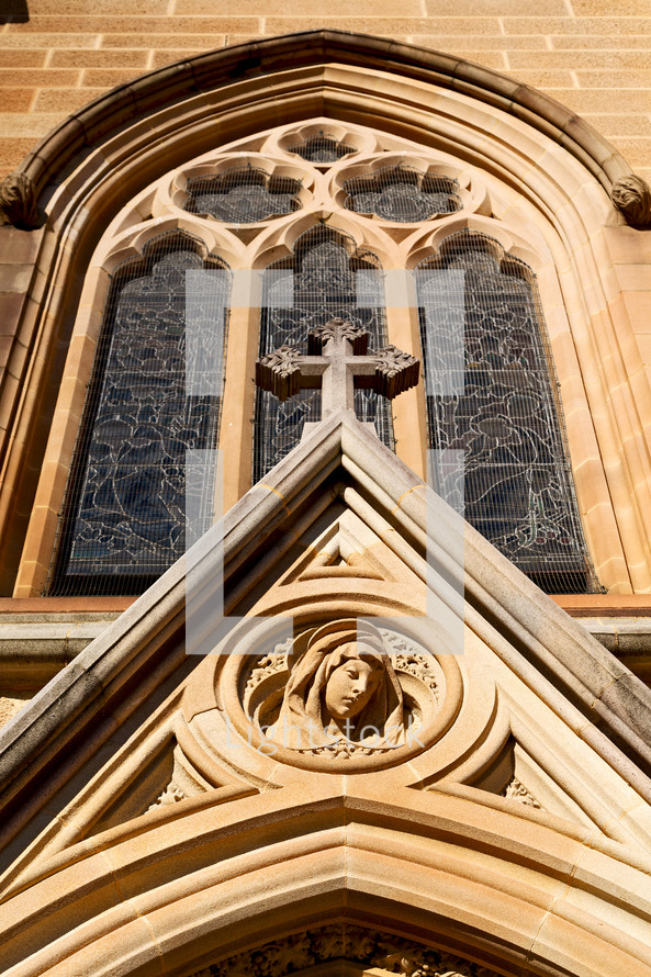 carving of Mary over a church entrance 