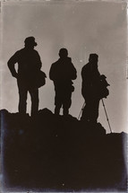 silhouettes of tourists holding camera 