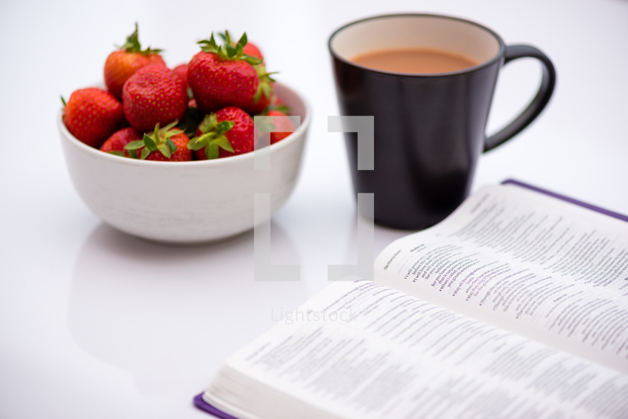 strawberries, coffee mug, and open Bible 