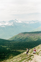 people hiking a mountain trail 