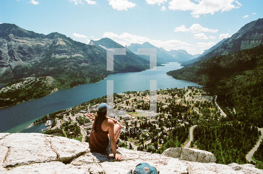 a woman overlooking a neighborhood on a mountain lake 