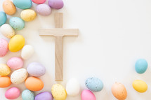 Wood cross with border of easter eggs on white background