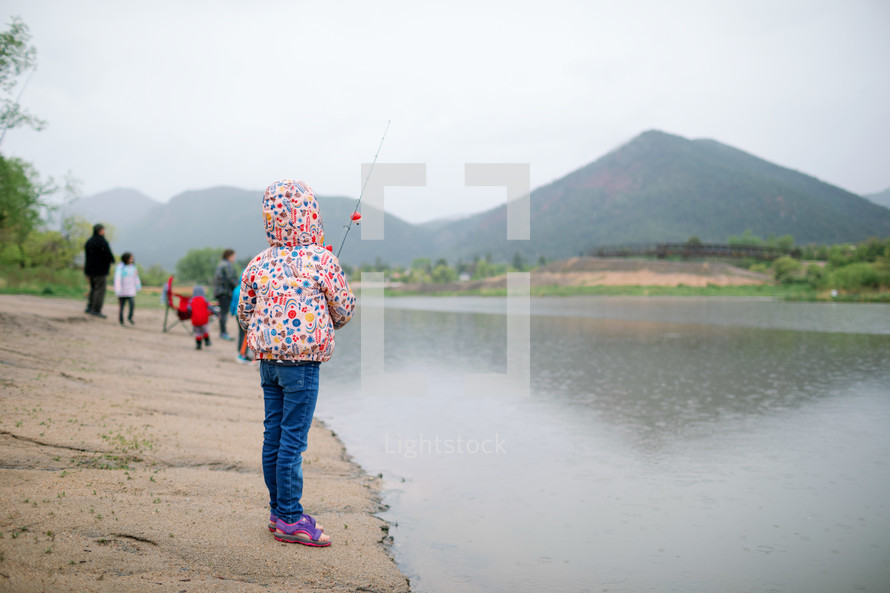 Little girl going fishing at the lake 