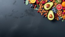 Healthy food background. Fruits, berries, nuts and superfoods on dark background