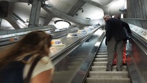 LONDON, UK - CIRCA SEPTEMBER 2019: Travellers on London Underground Tube station escalator