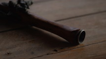 Pirate Hand gun on wooden table - tracking shot from barrel to handle