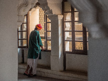 a man standing in a window in India 