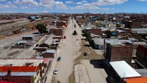 Aerial shot drone flies 10m off the ground down main street in dirt town
