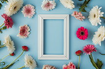 AI Generated Image. Flowers placed around empty photo frame on a blue background