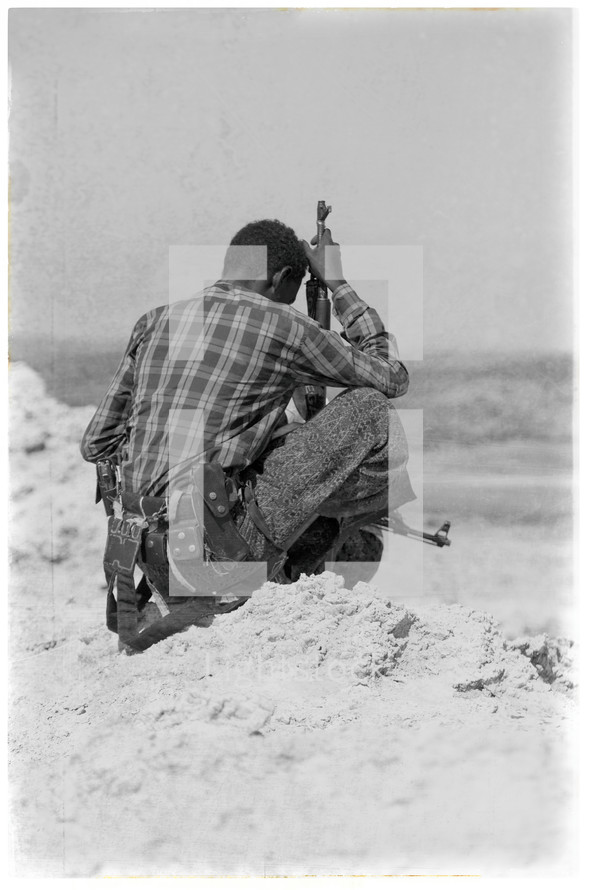 soldier in Africa holding a gun 