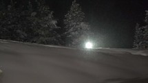 Snowboarder with headlamp under heavy snow 