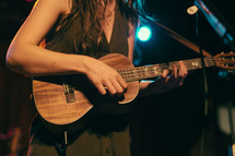 woman playing a ukulele 