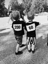 kids with numbers on their backs for a charity run 