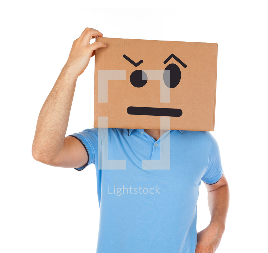 Young man standing with a cardboard box on his head with smiley face on white background.