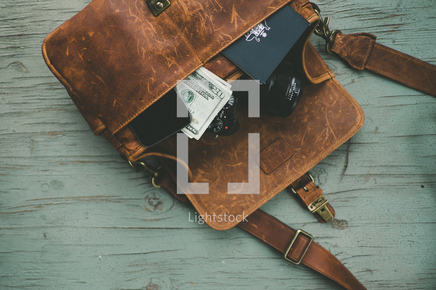 cash, cellphone, passport, camera in a messenger bag 