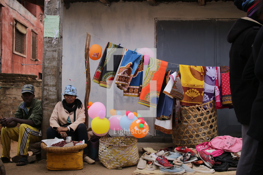 Street vendor selling fabrics and shoes