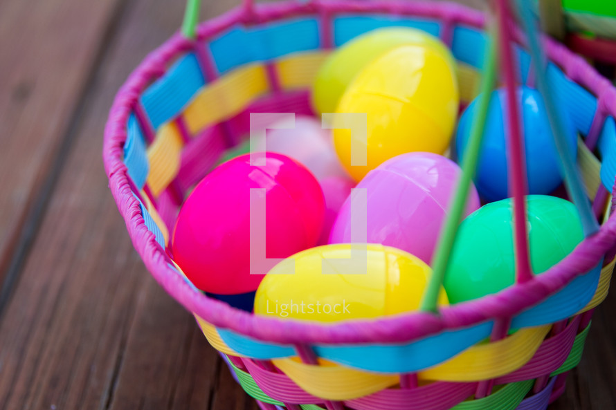 Colorful plastic Easter eggs in an Easter basket.