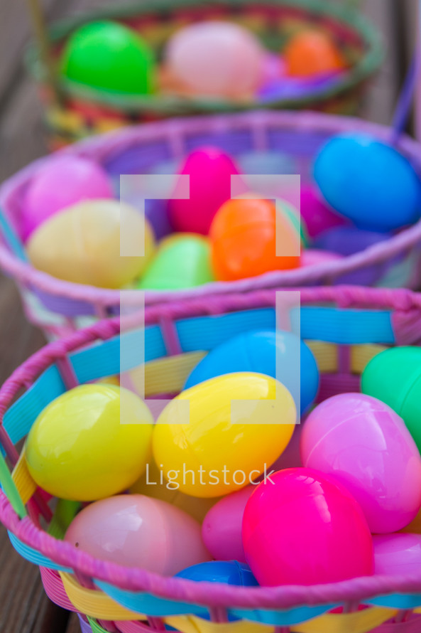 Colorful Easter baskets filled with plastic Easter eggs.