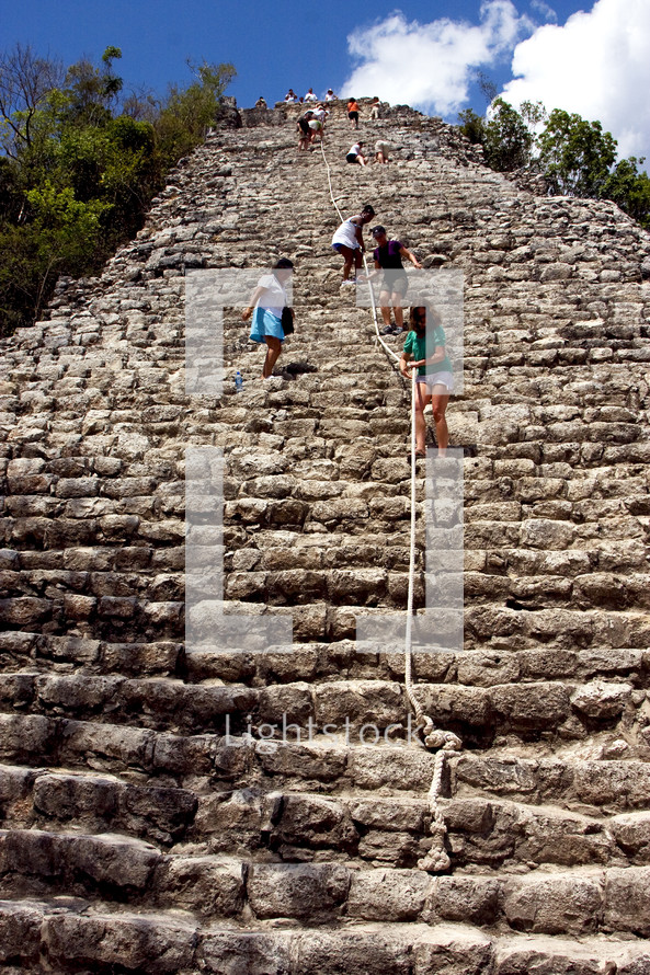 climbing the steep steps of the Coba temple 