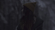 a woman standing outdoors in snow 