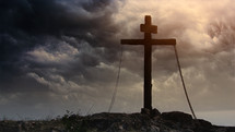 Wooden cross on a stormy day representing Sacrifice of Jesus Christ from Calvary hill.

