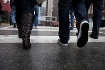 feet walking on a city crosswalk