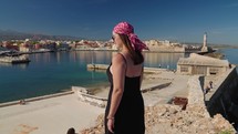 Woman tourist enjoying Bay Of Chania At Sunny Summer Day In Crete, Greece