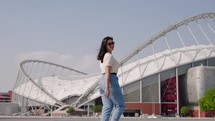 Woman walking in from Khalifa international stadium in Doha, Qatar. 2022 FIFA World Cup.
