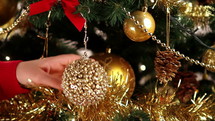 woman decorating a Christmas tree