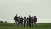 a group standing together in a field 