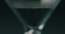 sand moving through an hourglass 